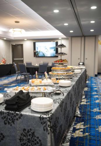 a long table with plates of food on it at Hampton Inn & Suites Dallas/Ft. Worth Airport South in Euless