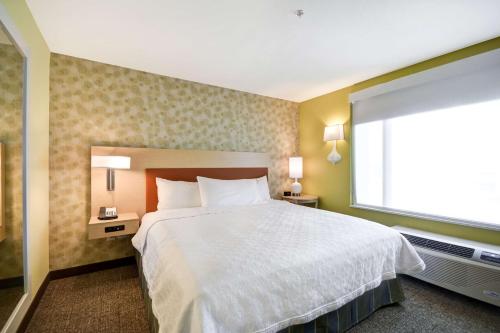 a bedroom with a large bed and a window at Home2 Suites By Hilton Dallas North Park in Dallas