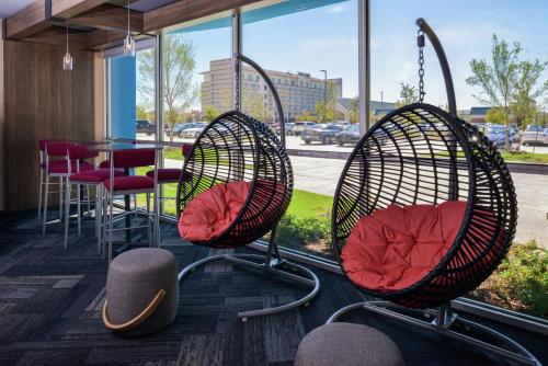 two chairs and a table in a room with a window at Tru By Hilton Coppell DFW Airport North in Coppell