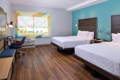 a hotel room with two beds and a desk at Tru By Hilton Coppell DFW Airport North in Coppell