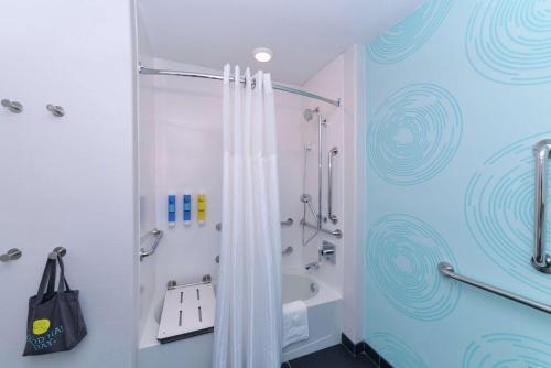 a bathroom with a shower with a shower curtain at Tru By Hilton Coppell DFW Airport North in Coppell