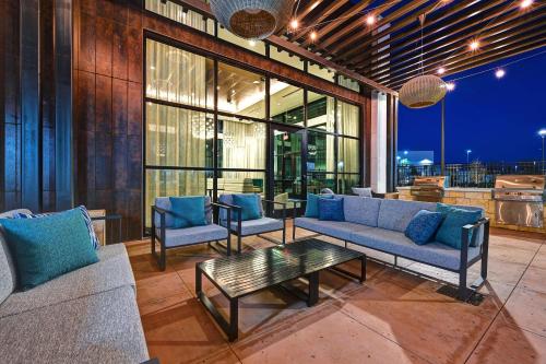 a living room with a couch and chairs and a table at Homewood Suites by Hilton Dallas The Colony in The Colony