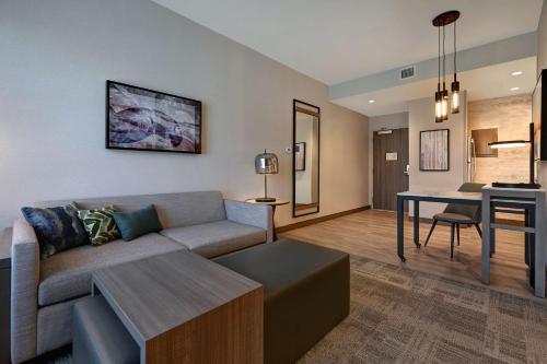 a living room with a couch and a table at Homewood Suites by Hilton Dallas The Colony in The Colony