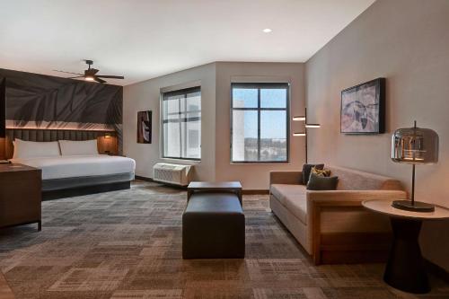 a hotel room with a bed and a couch at Homewood Suites by Hilton Dallas The Colony in The Colony