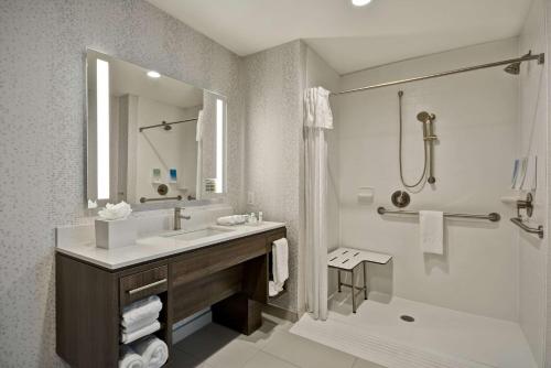 a bathroom with a sink and a shower and a tub at Home 2 Suites By Hilton Fairview Allen in Fairview