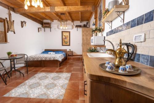 a bathroom with a sink and a bed in a room at לומינוס הגפן in Ḥurfeish