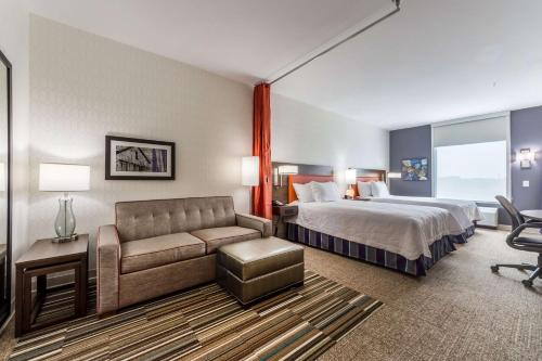 ein Hotelzimmer mit einem Bett und einem Sofa in der Unterkunft Home2 Suites By Hilton Fort Worth Northlake in Roanoke