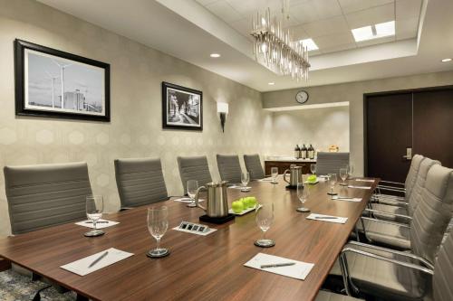 a conference room with a long wooden table and chairs at Embassy Suites By Hilton Denton Convention Center in Denton