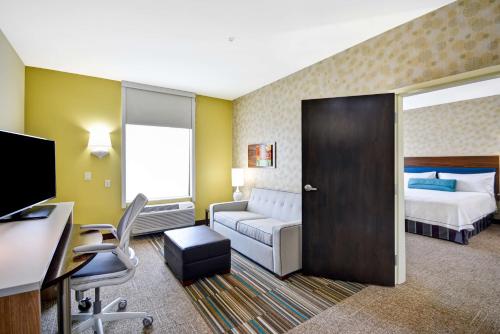 a hotel room with a bed and a desk at Home2 Suites By Hilton Fort Worth Southwest Cityview in Fort Worth