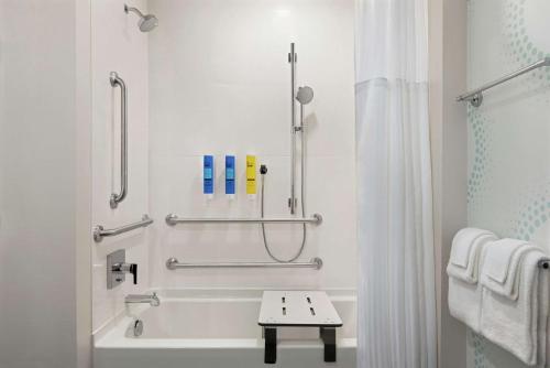 a bathroom with a tub and a shower with a sink at Tru By Hilton Duluth Mall Area in Duluth