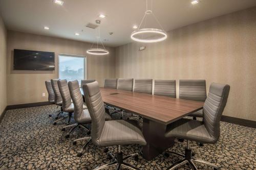 a conference room with a wooden table and chairs at Hampton Inn & Suites Dallas-The Colony in The Colony