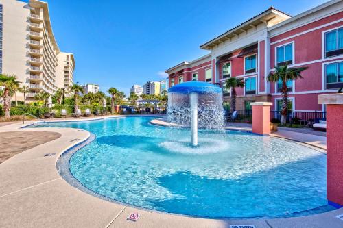 a fountain in a pool in front of a building at Hampton Inn & Suites Destin in Destin