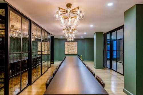 a long table in a room with a chandelier at Hotel Fort Des Moines, Curio Collection By Hilton in Des Moines