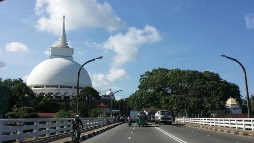 a bridge with a building with a large white domicism at Sunset Beach Residence in Panadura