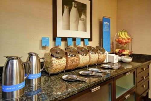 a counter with a bunch of cups and bowls on it at Hampton Inn & Suites Detroit-Canton in Canton