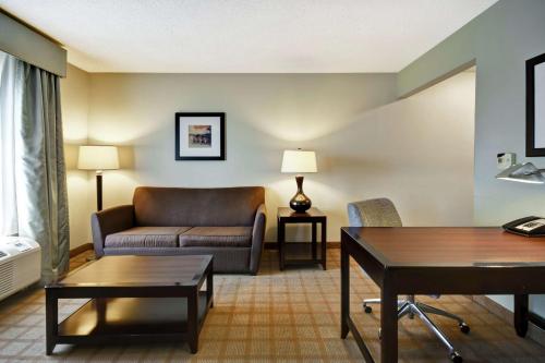 a living room with a couch and a table at Hampton Inn & Suites Detroit-Canton in Canton