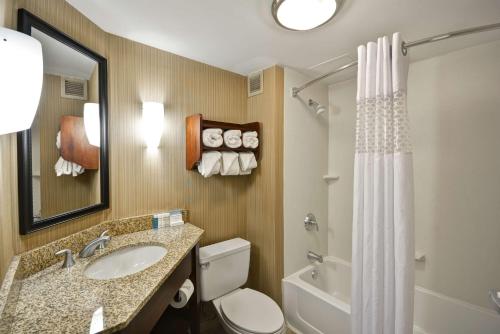 a bathroom with a sink and a toilet and a shower at Hampton Inn Detroit Northville in Northville