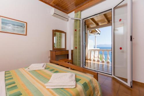 a bedroom with a bed and a view of the ocean at Dolphin Villa 2 in Porto Ozias