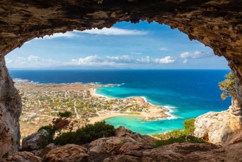 a view from a cave of a beach and ocean at Villa Konstantina in Exopoli
