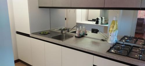 a kitchen counter with a sink and a stove at Appartamento di Anna in La Spezia