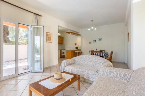 a living room with a couch and a table at Villa Youla in Nisaki
