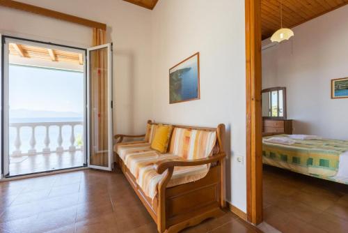 a living room with a bed and a balcony at Dolphin Villa 3 in Porto Ozias