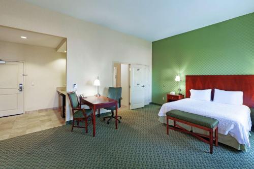a hotel room with a bed and a table and chairs at Hampton Inn & Suites El Paso West in El Paso