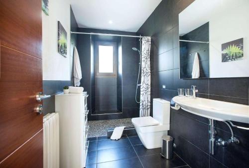 a bathroom with a sink and a toilet and a shower at Ses Cases Noves by Vintage Travel in Banyalbufar