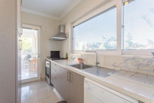 a kitchen with a sink and a large window at Villa Nirvana in Mugla
