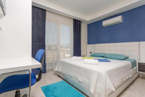 a bedroom with a bed with blue walls and blue chairs at Villa Nirvana in Mugla