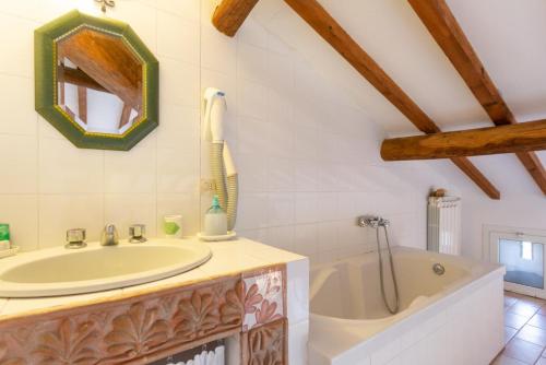 a bathroom with a tub and a sink at Villa Il Giulione Large Private Pool WiFi in Trevinano