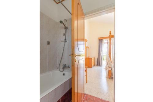 a bathroom with a tub and a shower at Sun Beach Villa Thio in Polis Chrysochous