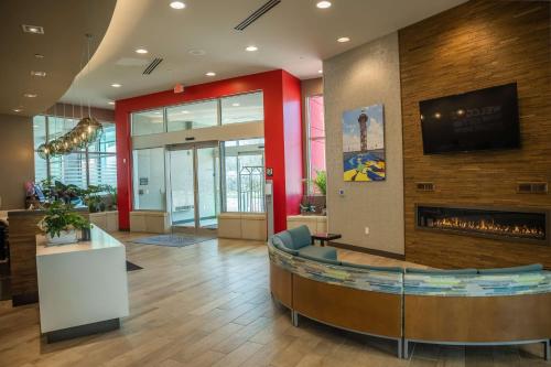 a lobby with a fireplace in a building at Hampton Inn & Suites Erie Bayfront in Erie