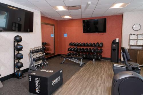 a gym with dumbbells and a television in a room at Hampton Inn & Suites Erie Bayfront in Erie