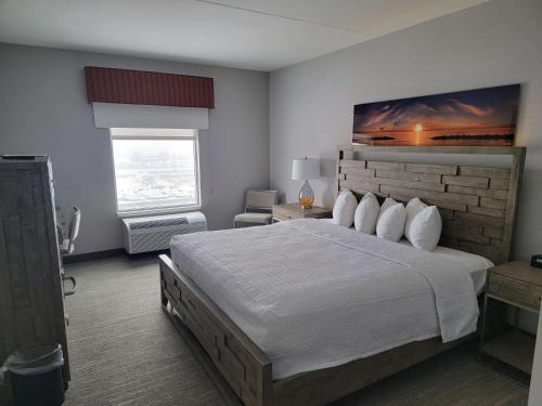 a bedroom with a large bed and a large window at Hampton Inn & Suites Erie Bayfront in Erie
