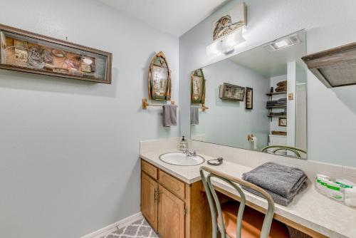 a bathroom with a sink and a mirror at Charming Cloudcroft Retreat with Fire Pit! in Cloudcroft