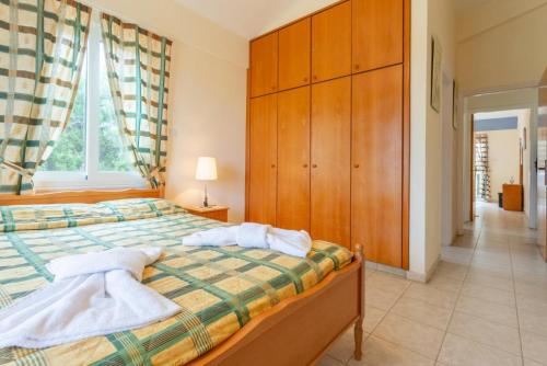 a bedroom with a bed with two towels on it at Villa Christia Maris in Neo Chorio