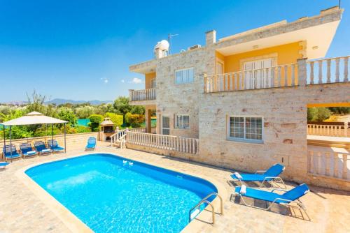 a villa with a swimming pool in front of a house at Villa Prodromi Large Private Pool AC WiFi in Prodhromi