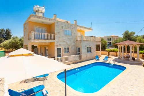 a villa with a swimming pool and an umbrella at Villa Prodromi Large Private Pool AC WiFi in Prodhromi