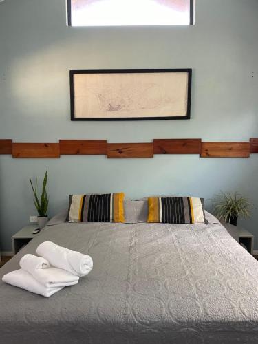 a bedroom with a bed with two towels on it at Spacious modern apartments in Noord