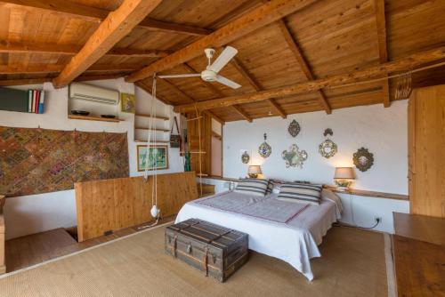a bedroom with a bed and a wooden ceiling at The Olive Press - Agni Bay in Agní