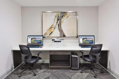 an office with two computers on a desk with two chairs at Hampton Inn Eufaula Al in Eufaula