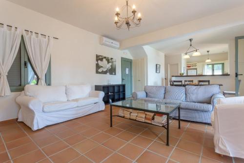 a living room with two couches and a table at Villa Vali in Trapezaki