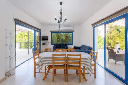 a dining room with a table and chairs at Villa Charoula Tria Large Private Pool AC WiFi in Paphos
