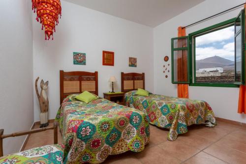 a room with two beds and a window at Villa Sol Y Mar in Yaiza