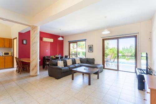 a living room with a couch and a table at Villa Halima Stefanos in Polis Chrysochous