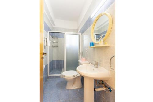 a bathroom with a sink and a toilet and a mirror at Villa Halima Stefanos in Polis Chrysochous