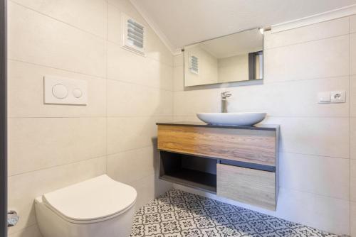 a bathroom with a white toilet and a sink at Villa Asli Paradise in Mugla
