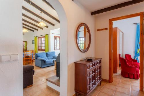 a living room with a blue couch and a mirror at Villa Ca Nostra in Cala'n Porter
