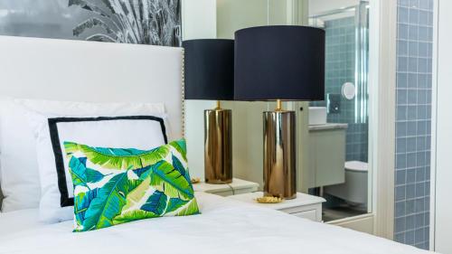 a bedroom with a bed with a pillow and two lamps at Downtown PortoEdition in Porto